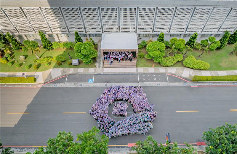 About 400 people gathered in a pop-up event in front of the administrative building to display the bureau emblem.